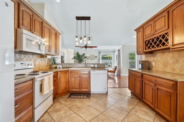 kitchen featuring decorative light fixtures, white appliances, tasteful backsplash, sink, and ceiling fan