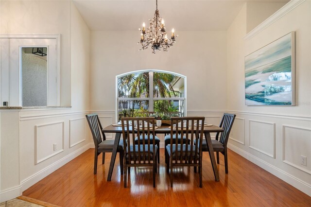 dining room featuring hardwood / wood-style floors and an inviting chandelier