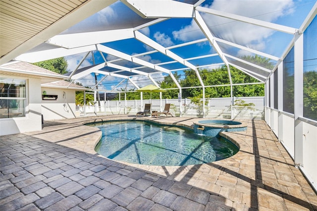 view of pool with glass enclosure, a patio, a fenced backyard, and a pool with connected hot tub