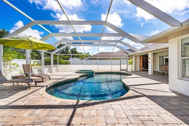 view of swimming pool with a lanai and a patio