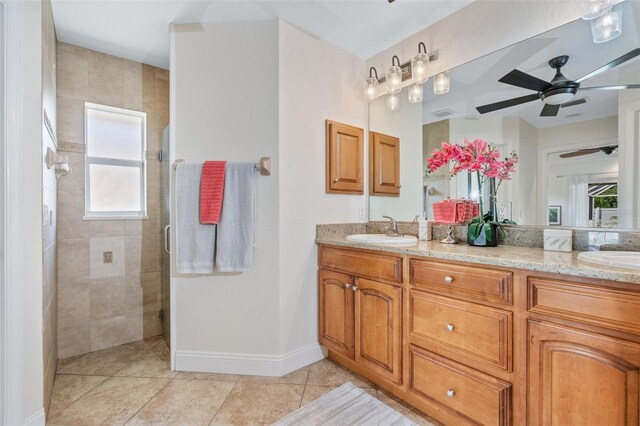 bathroom with ceiling fan, a shower with door, a wealth of natural light, and vanity