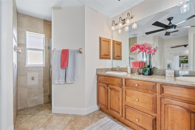 full bathroom with double vanity, tile patterned floors, tiled shower, and a sink