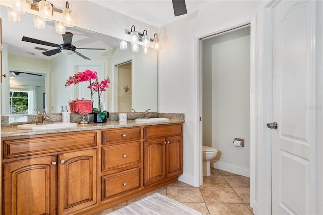 full bath featuring a sink, toilet, double vanity, and tile patterned flooring