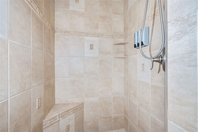 full bath with a tile shower