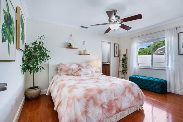 bedroom featuring ceiling fan, dark hardwood / wood-style flooring, and ornamental molding