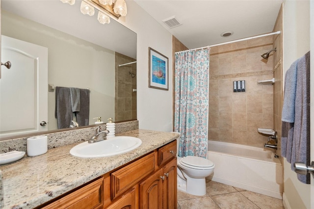 full bathroom featuring shower / bath combo with shower curtain, tile patterned floors, toilet, and vanity