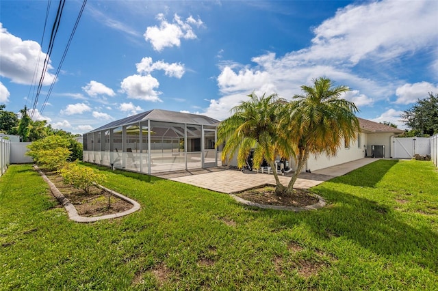 back of house featuring a lanai, a yard, a patio, and a fenced backyard