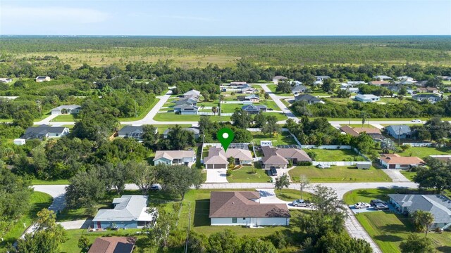 aerial view featuring a residential view and a wooded view