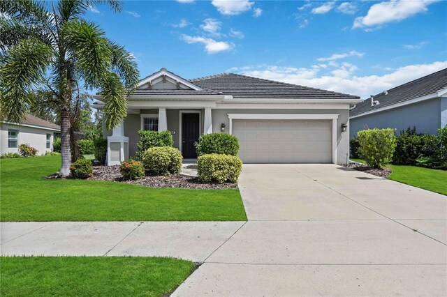 view of front of property featuring a garage and a front yard