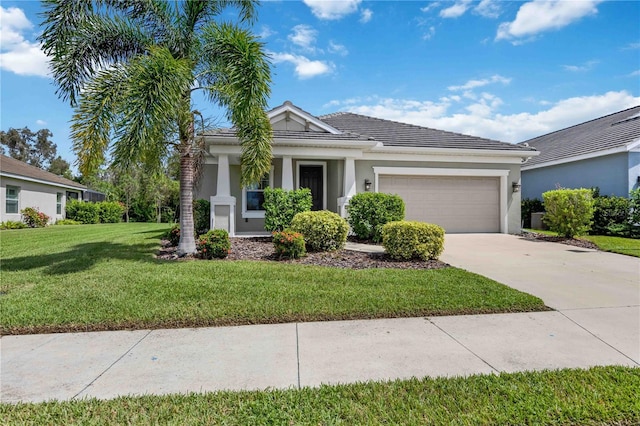 view of front of house featuring a front yard, driveway, an attached garage, stucco siding, and a tile roof