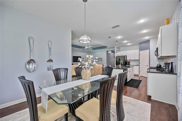 dining room with sink and dark hardwood / wood-style flooring