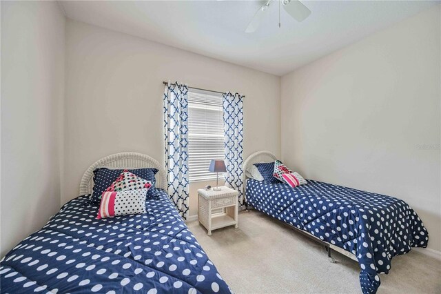 bedroom featuring light colored carpet and ceiling fan