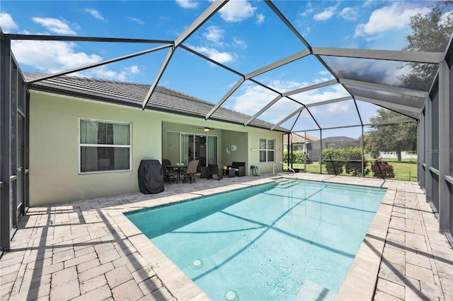 view of pool featuring ceiling fan, a lanai, and a patio