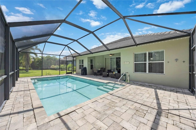 view of pool with glass enclosure, ceiling fan, and a patio