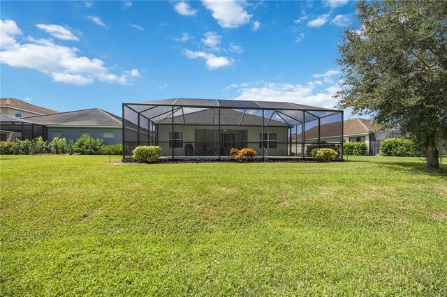 view of yard with glass enclosure