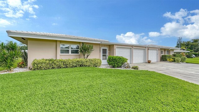 ranch-style house with a front yard and a garage