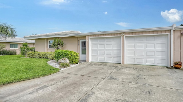 ranch-style home with a front yard and a garage