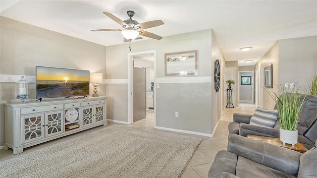 living room with light tile patterned floors and ceiling fan