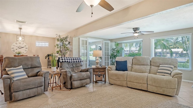 living room with light tile patterned floors, a wealth of natural light, and ceiling fan