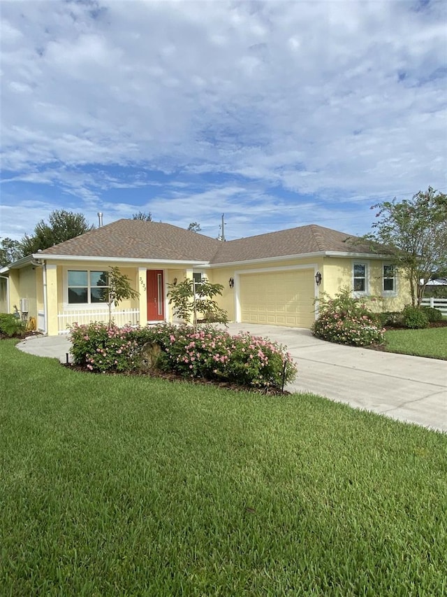 ranch-style house with a garage and a front lawn