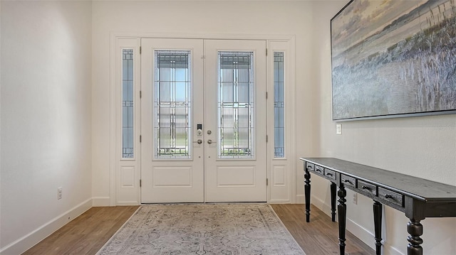 foyer with wood-type flooring and french doors