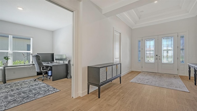 entrance foyer featuring a wealth of natural light, light hardwood / wood-style floors, crown molding, and french doors