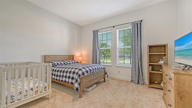 carpeted bedroom with lofted ceiling