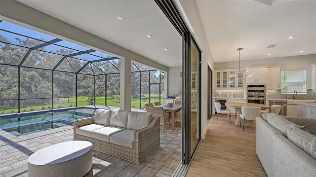 interior space with sink, an outdoor kitchen, and a lanai