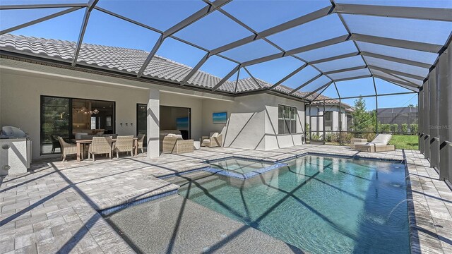 view of pool featuring a lanai and a patio