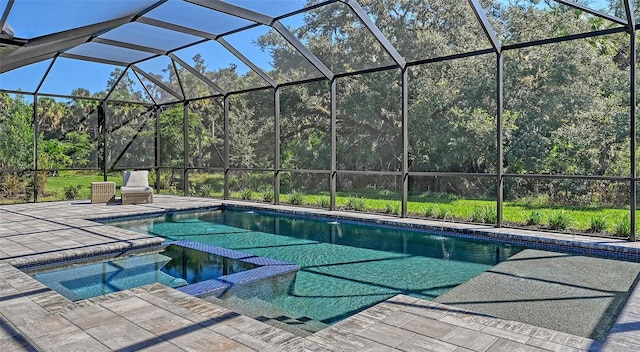 view of pool with glass enclosure and a patio area