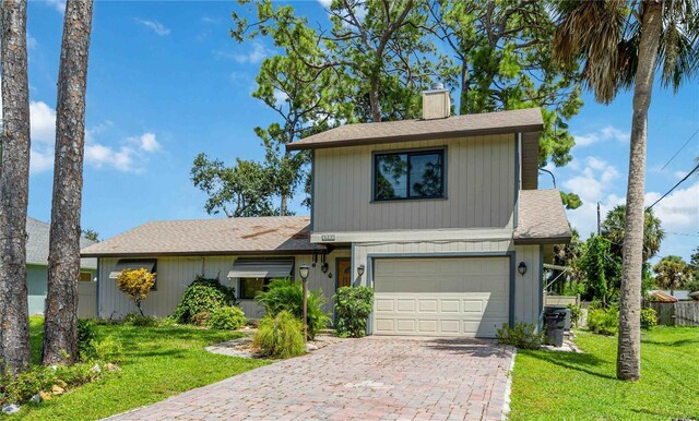 view of front property with a garage and a front lawn