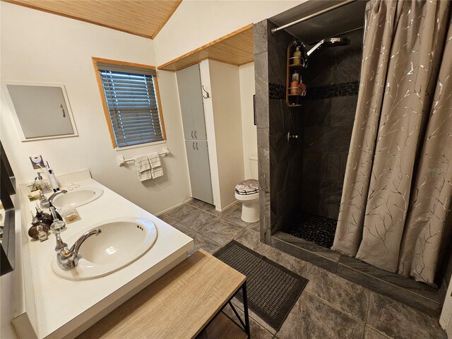 bathroom with toilet, vaulted ceiling, wooden ceiling, vanity, and curtained shower