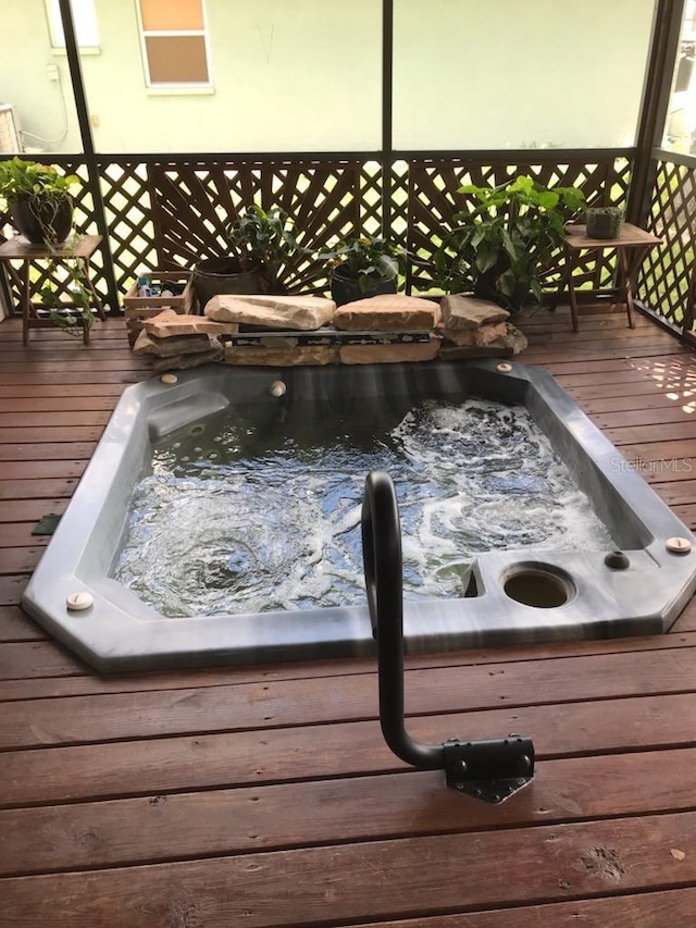 wooden deck with hot tub deck surround