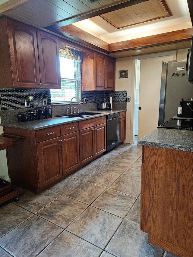 kitchen with freestanding refrigerator, a sink, decorative backsplash, black dishwasher, and dark countertops