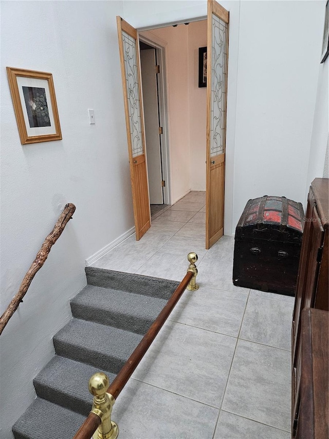 stairway featuring tile patterned flooring