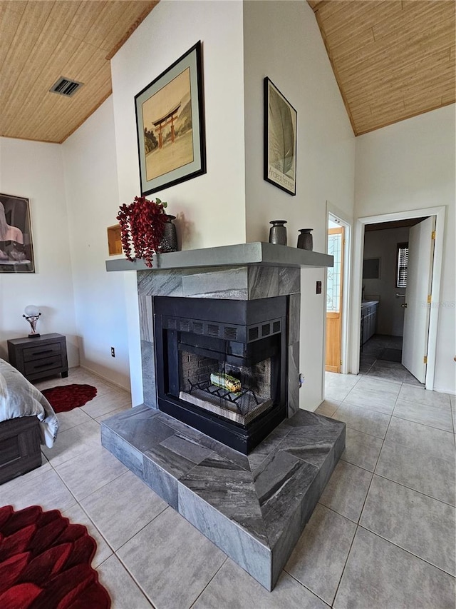 details with visible vents, wooden ceiling, and a tiled fireplace