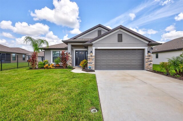 view of front of home featuring a front yard and a garage