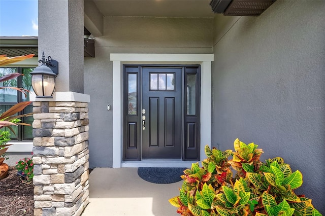 property entrance featuring stucco siding