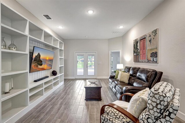 living room with wood-type flooring and french doors