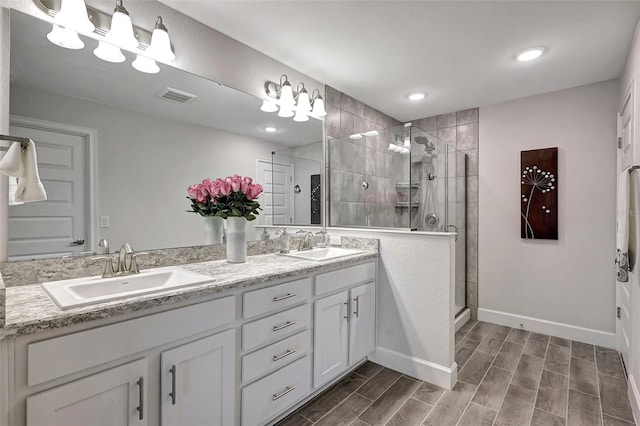 bathroom featuring an enclosed shower, hardwood / wood-style flooring, and vanity