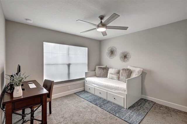 interior space with carpet flooring and ceiling fan