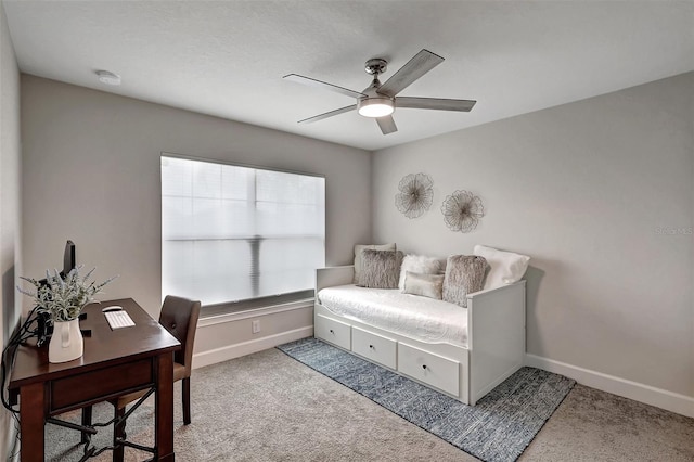 carpeted office with baseboards and ceiling fan