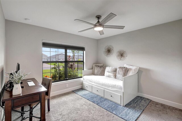 interior space featuring ceiling fan and carpet