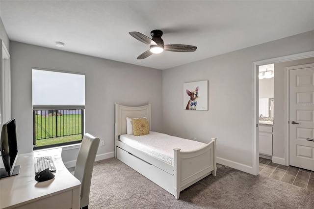 carpeted bedroom with ceiling fan and ensuite bath