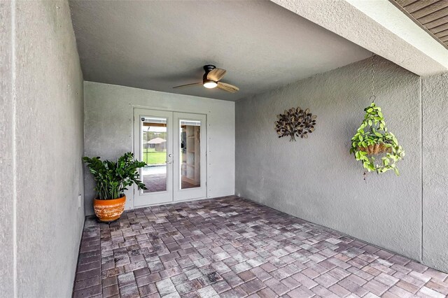 property entrance with ceiling fan, a patio area, and french doors