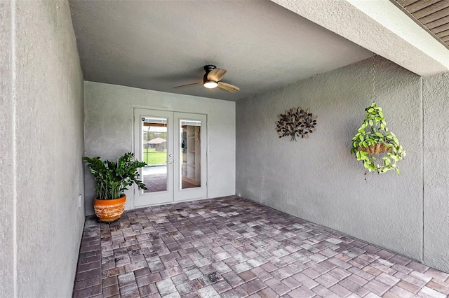 view of exterior entry with french doors and ceiling fan