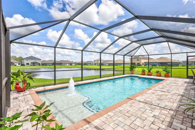 view of swimming pool with glass enclosure, a lawn, a patio, and a water view