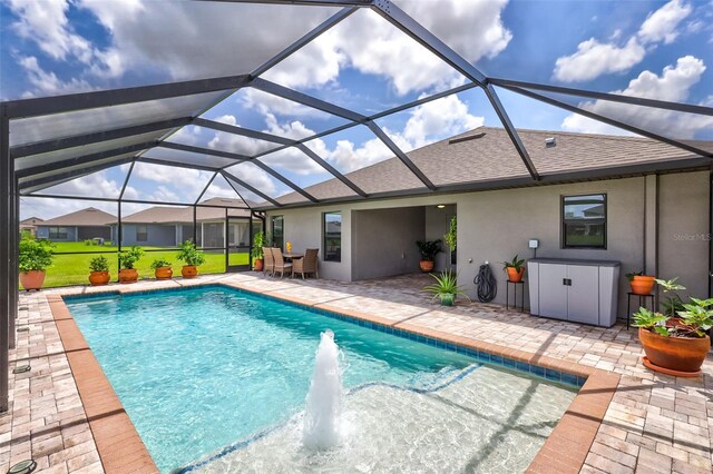 view of swimming pool with glass enclosure and a patio