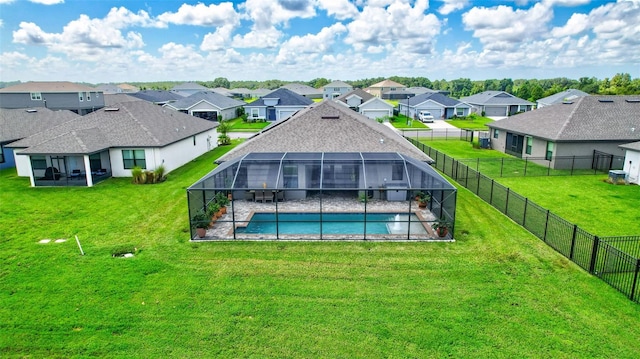 view of pool with a yard, a residential view, and a lanai