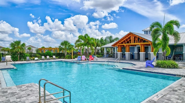 community pool featuring a patio and fence